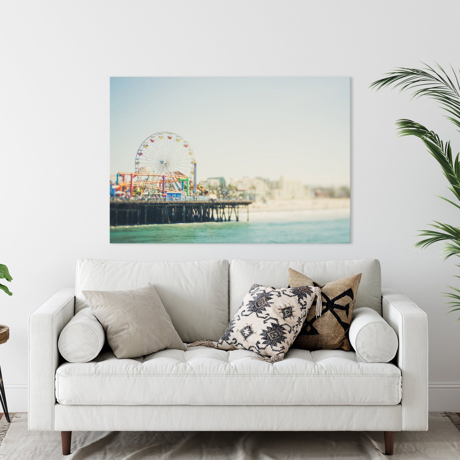 A Canvas of a Photograph of Santa Monica Pier hung over a Couch