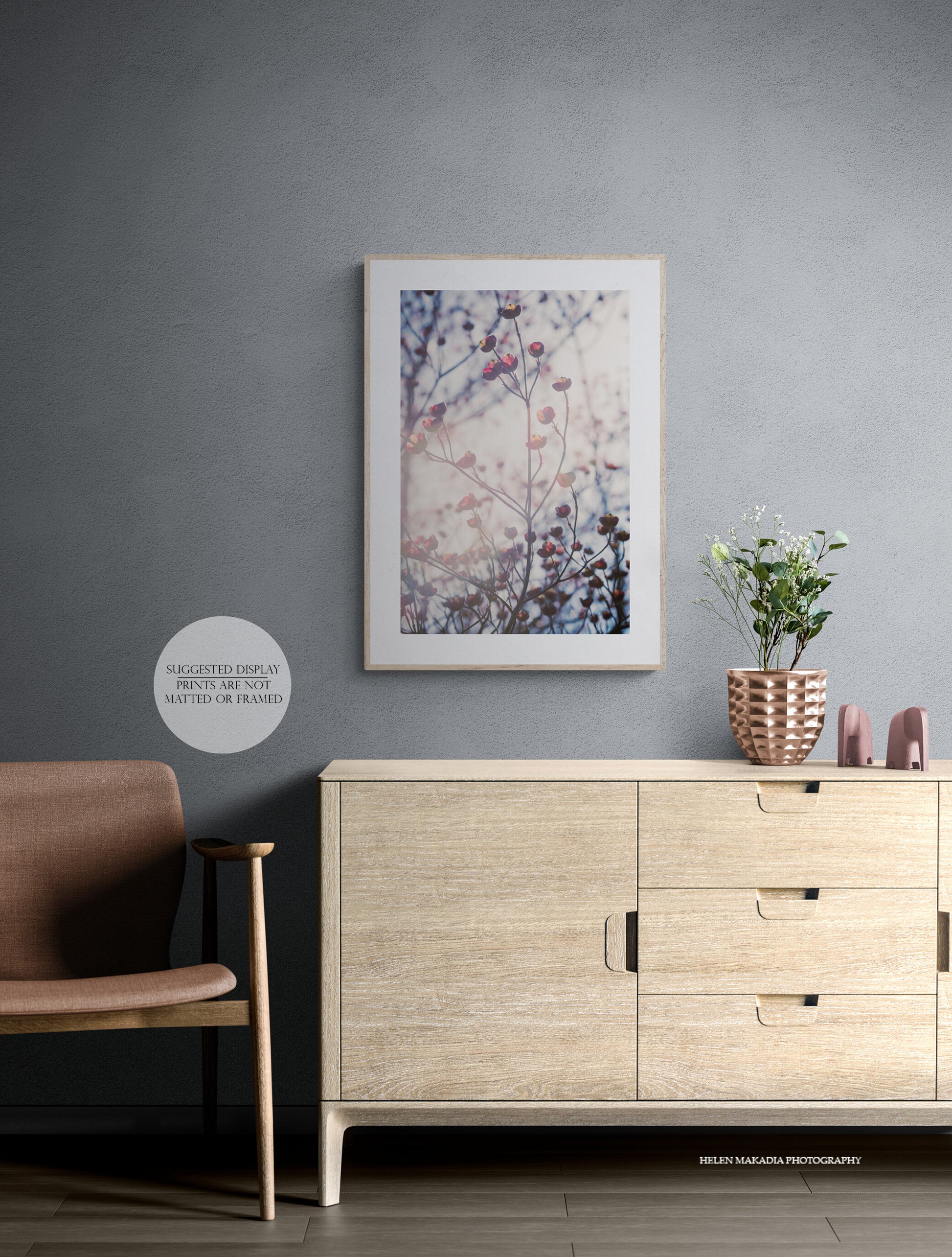 Sunlit pink dogwood blooms photograph as wall art in a living room