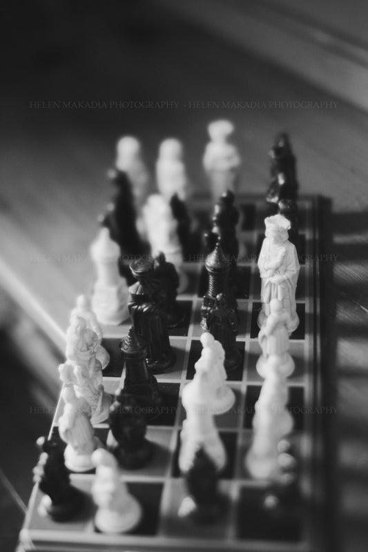 Black & White Photograph of Chess Pieces and Board