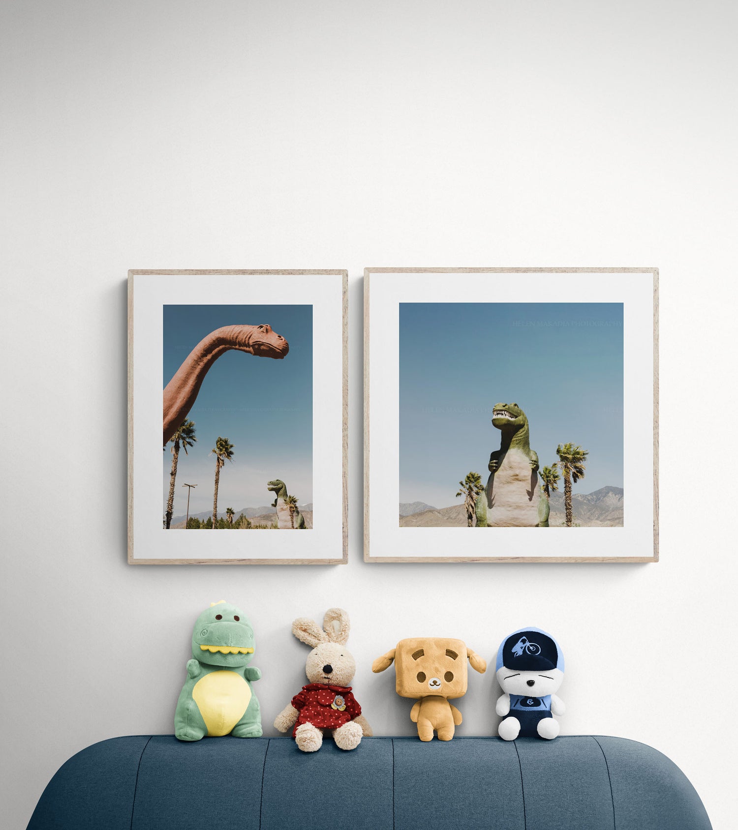 Two framed wall art prints of Cabazon dinosaurs in a playroom