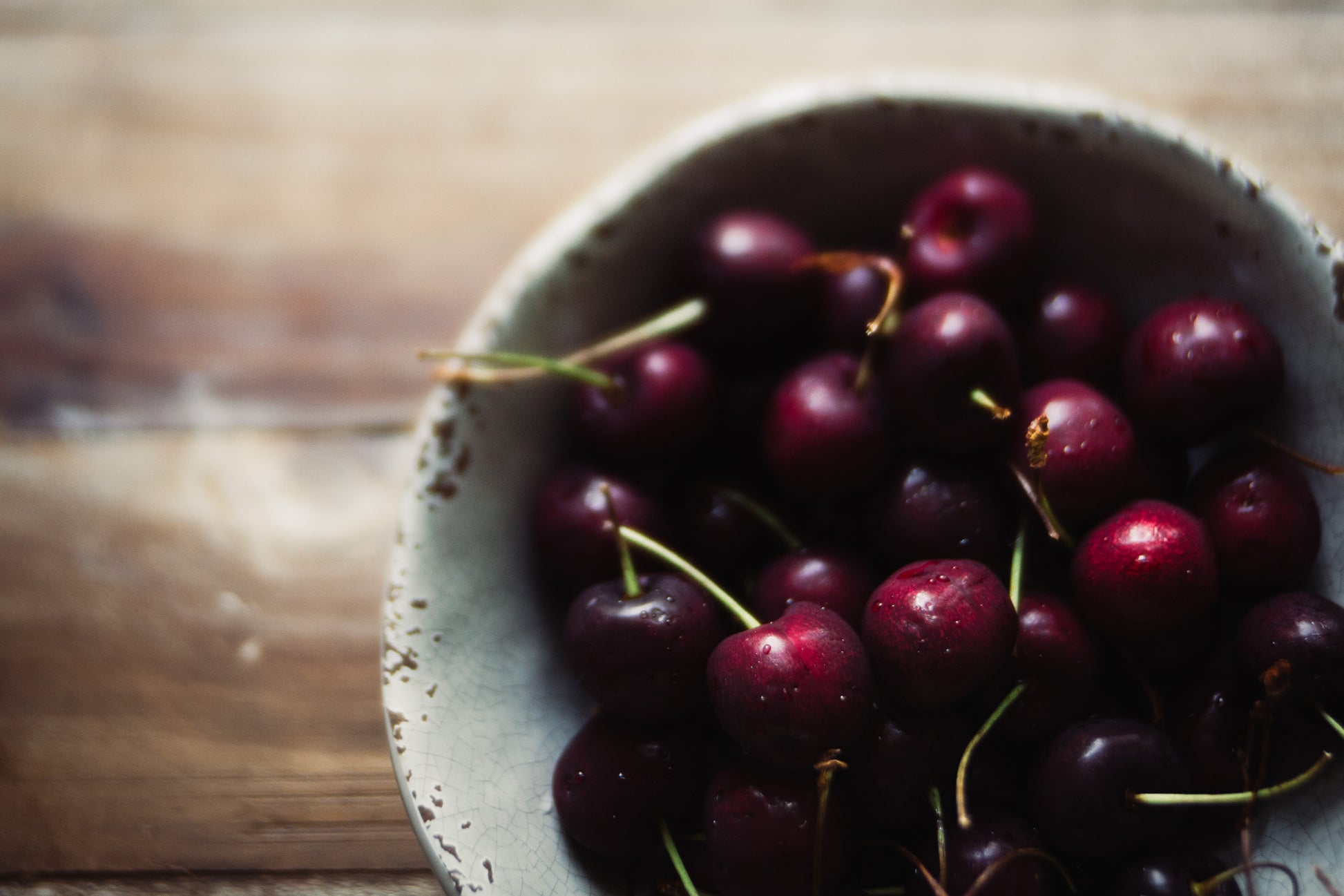 Photograph of a bowl of red cherries 