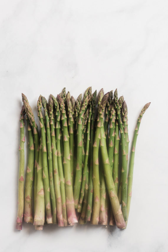 Photograph of asparagus on white marble as kitchen wall art