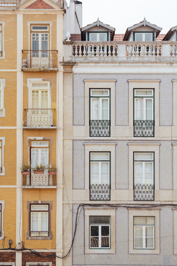 Photograph of tiled buildings of Lisbon Portugal, with balconies and large windows.