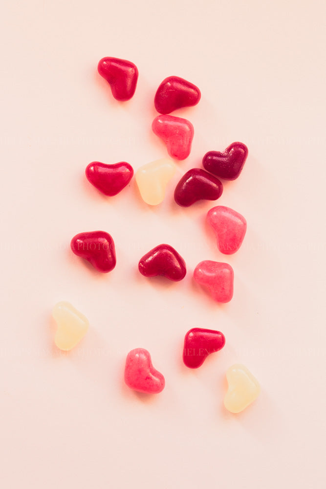 Photograph of heart shaped candy in white, soft pink and hot pink hues.