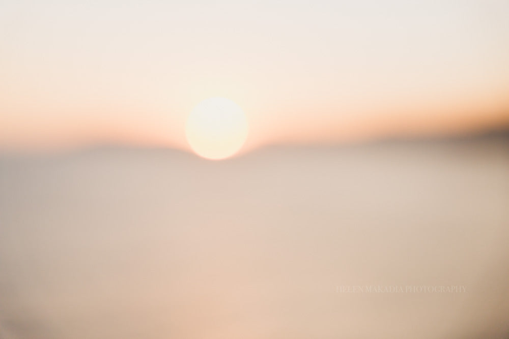 An abstract photograph of the sun setting into the horizon