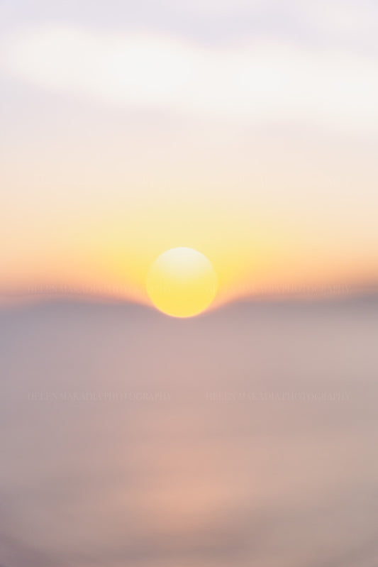 Photograph of sun dipping into the horizon during a sunset