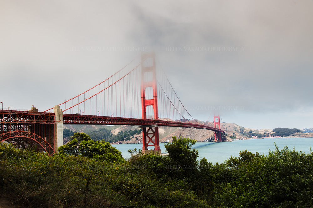 A photograph of the Golden Gate Bridge in San Francisco, California, with a cloudy sky.