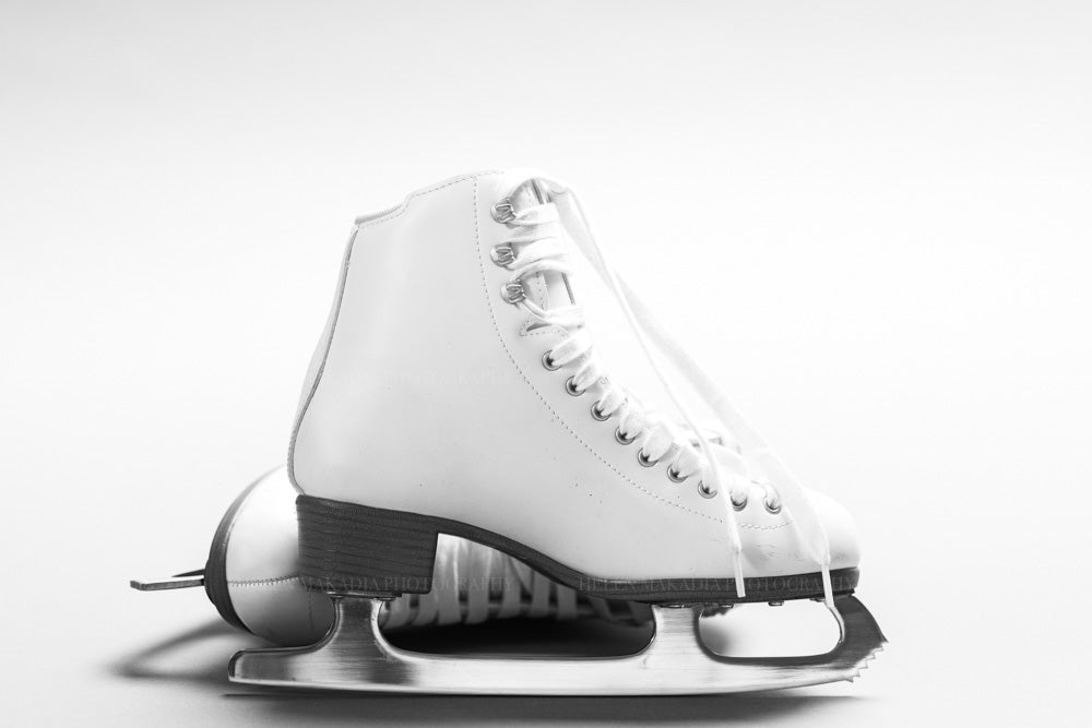 A photograph of white ice skates