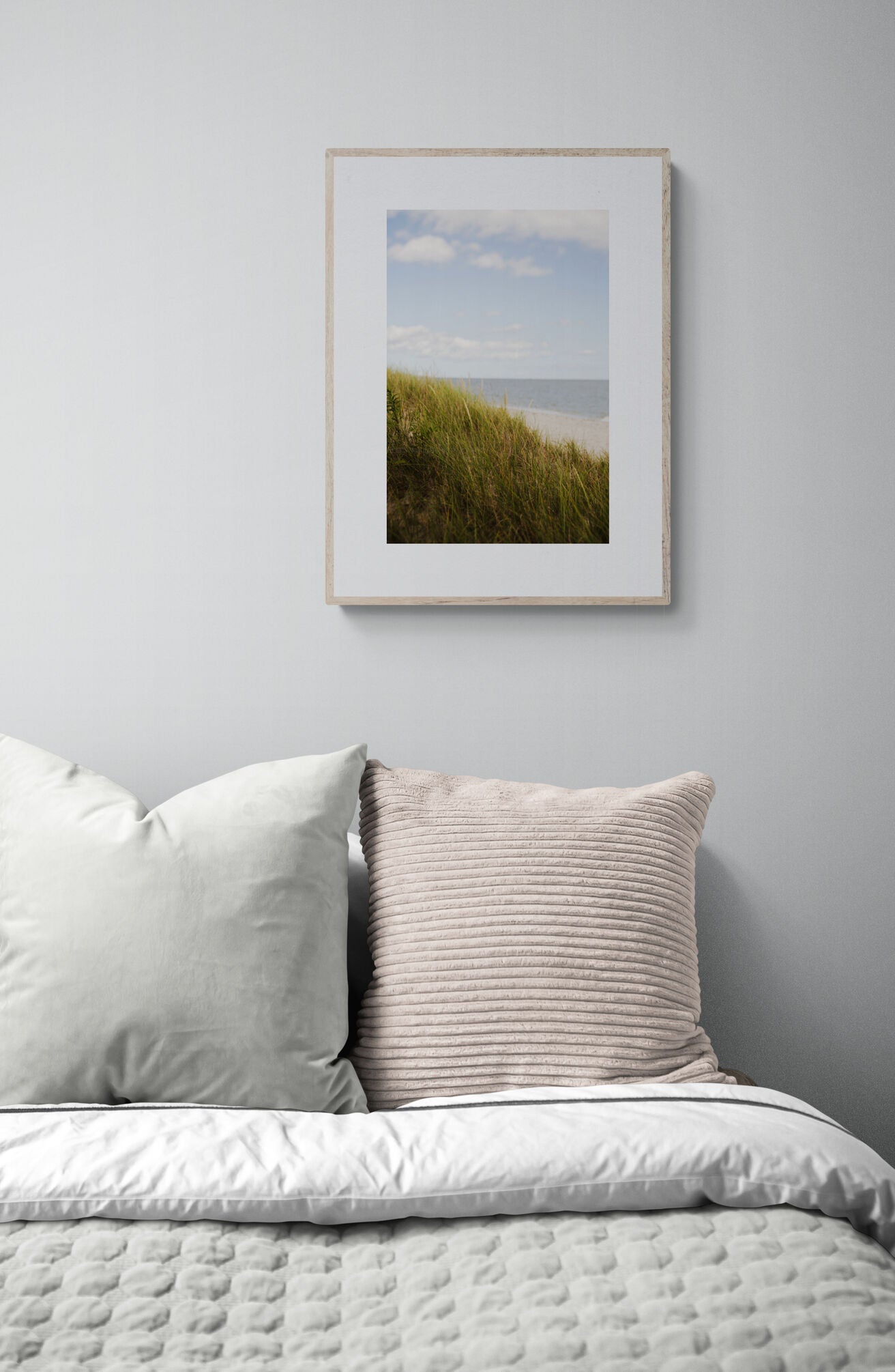 Beach photograph with seagrass, sand and water in a bedroom as wall art