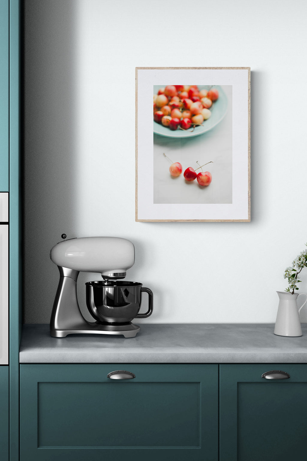 photograph of colorful rainier cherries on a blue platter as wall art in a kitchen