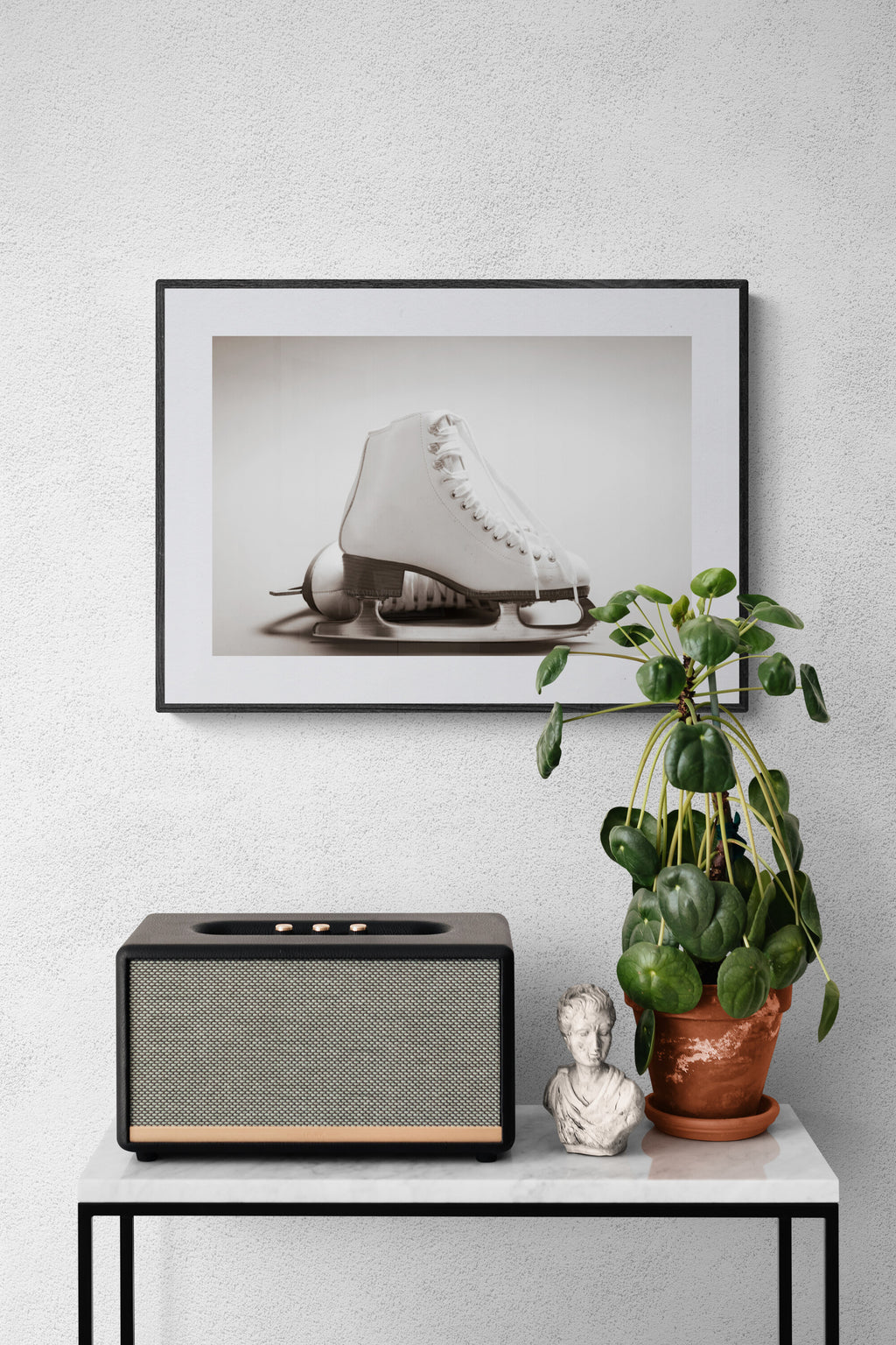A photograph of white figure skates as wall art decor.