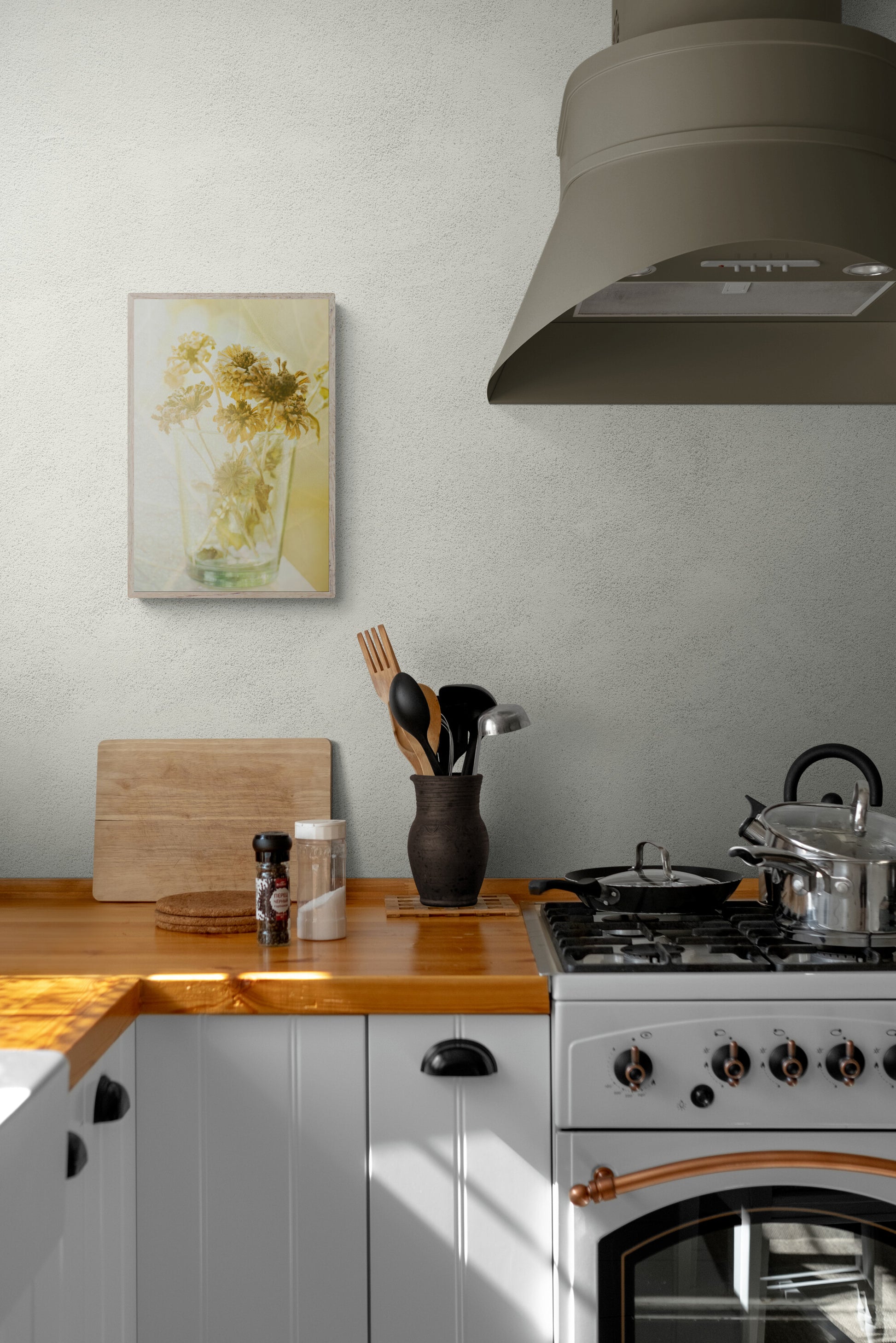 A photograph of dried zinnias with warm tones in a kitchen as well art.
