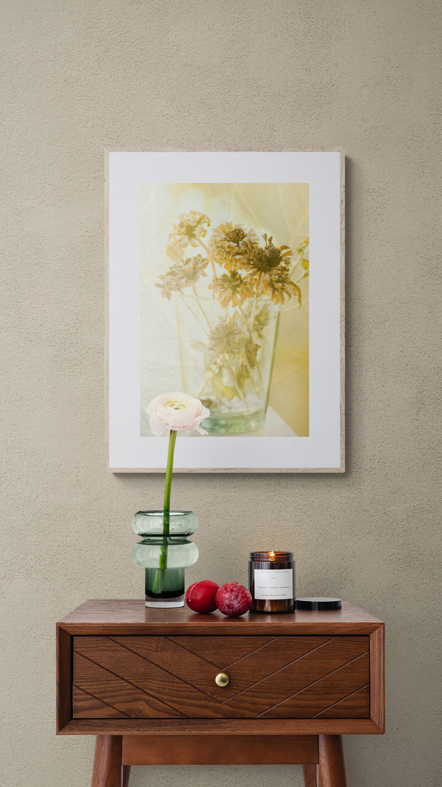 A photograph of dried zinnias with warm tones in a hallway as well art.