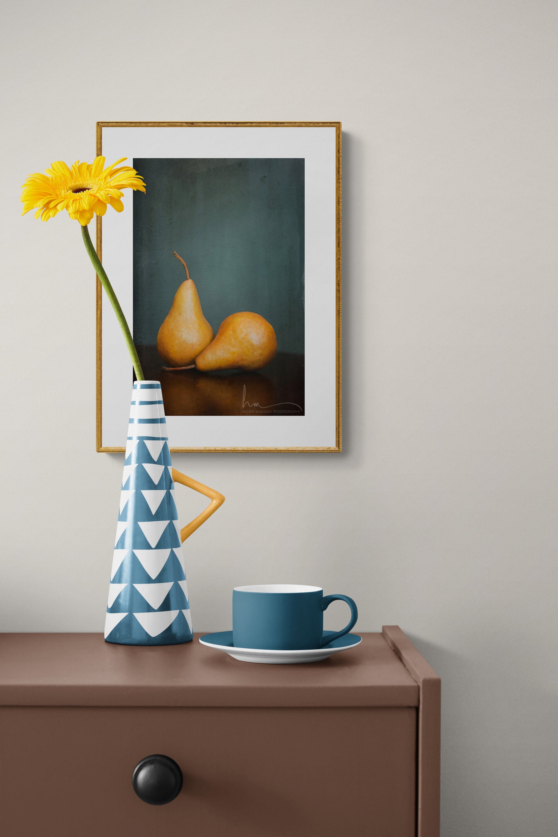 Framed photograph of brown pears in a dining room as wall art