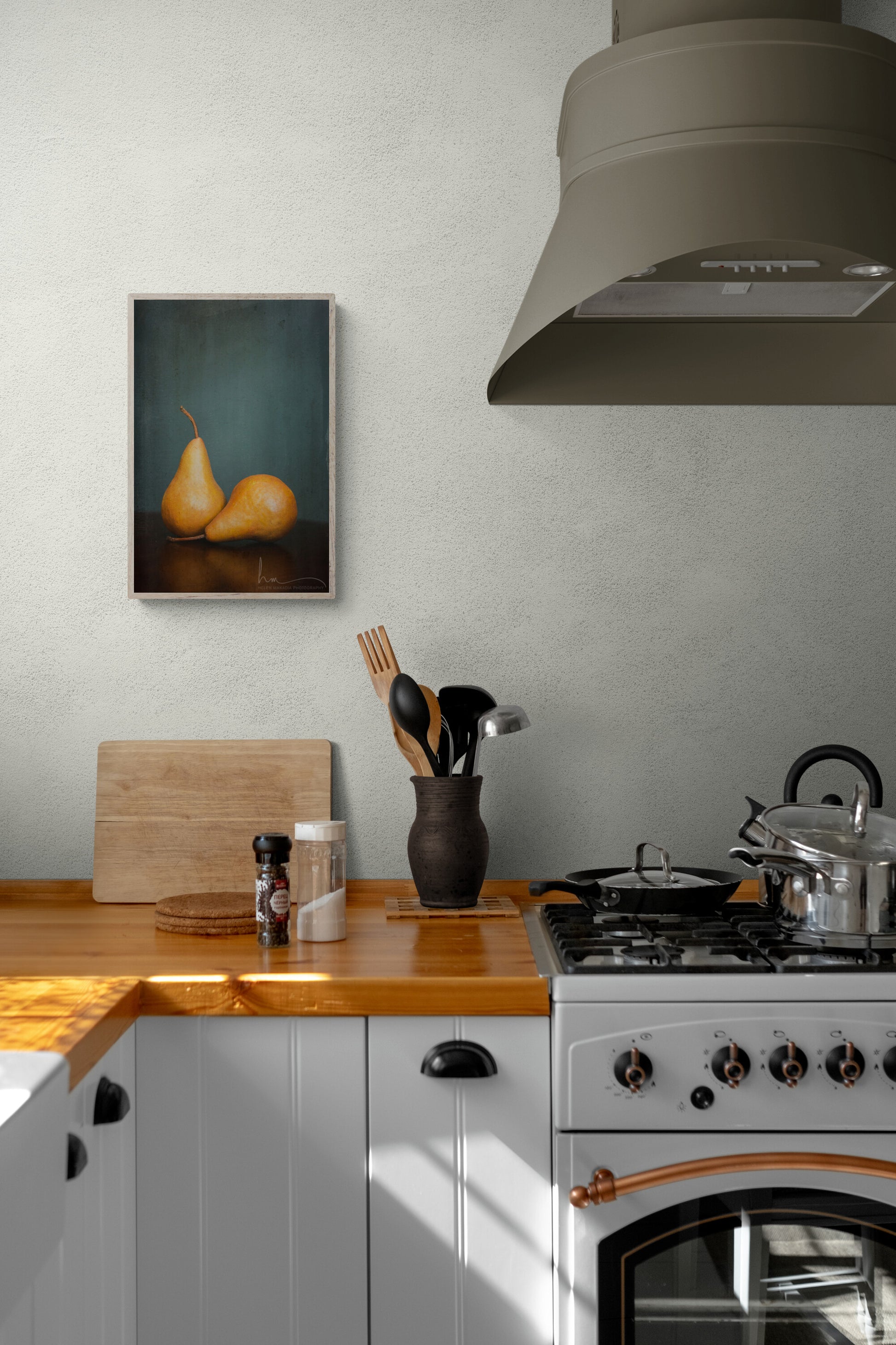 A farmhouse kitchen with a framed photograph of brown pairs as wall art.