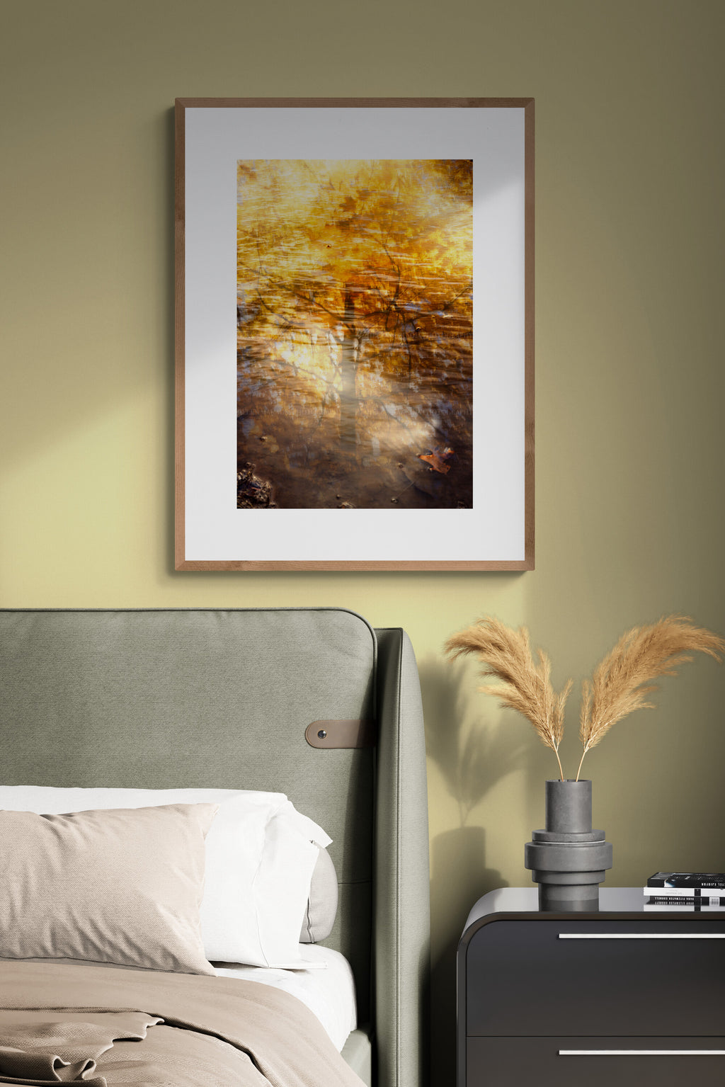 Framed photograph of reflections of a golden maple tree and wall art in a bedroom. 
