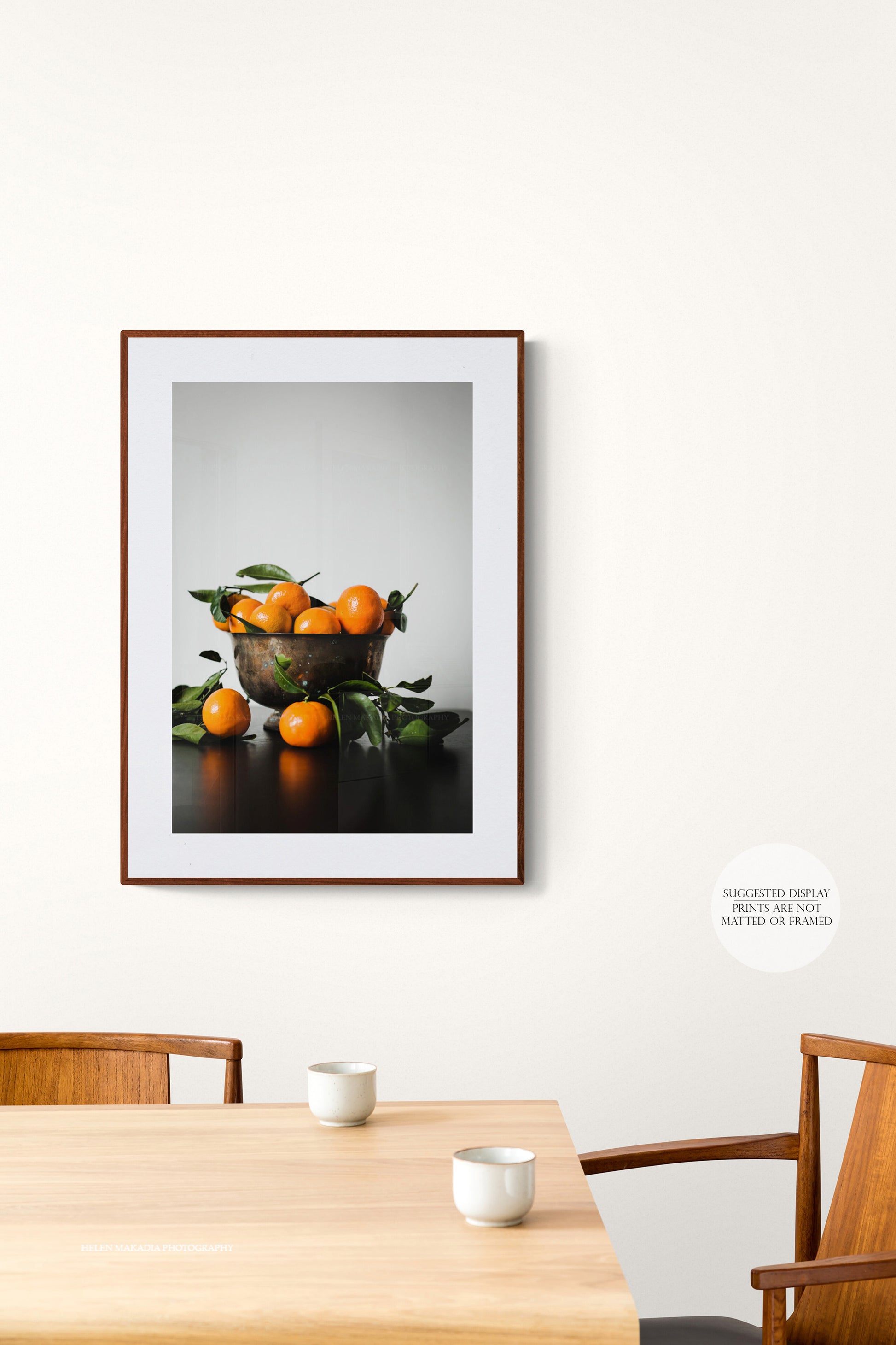 Photograph of a bowl of mandarin citrus in a dining room