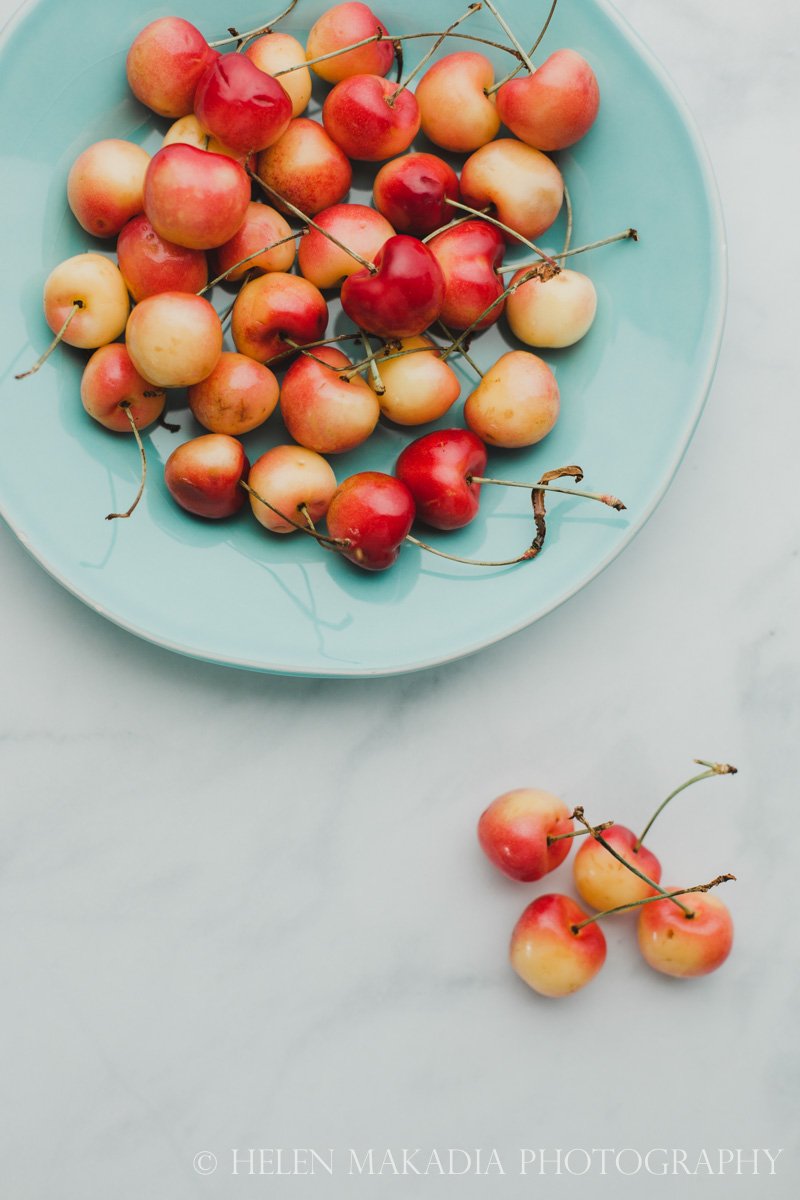 Rainer Cherries on a Teal Plate Print