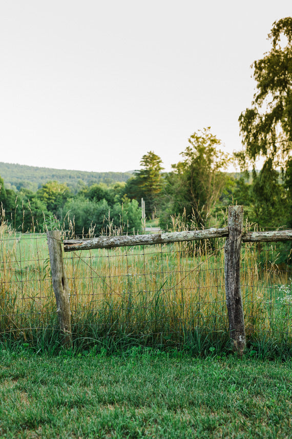 Wooden Fence and Country Field at Golden Hour Photograph