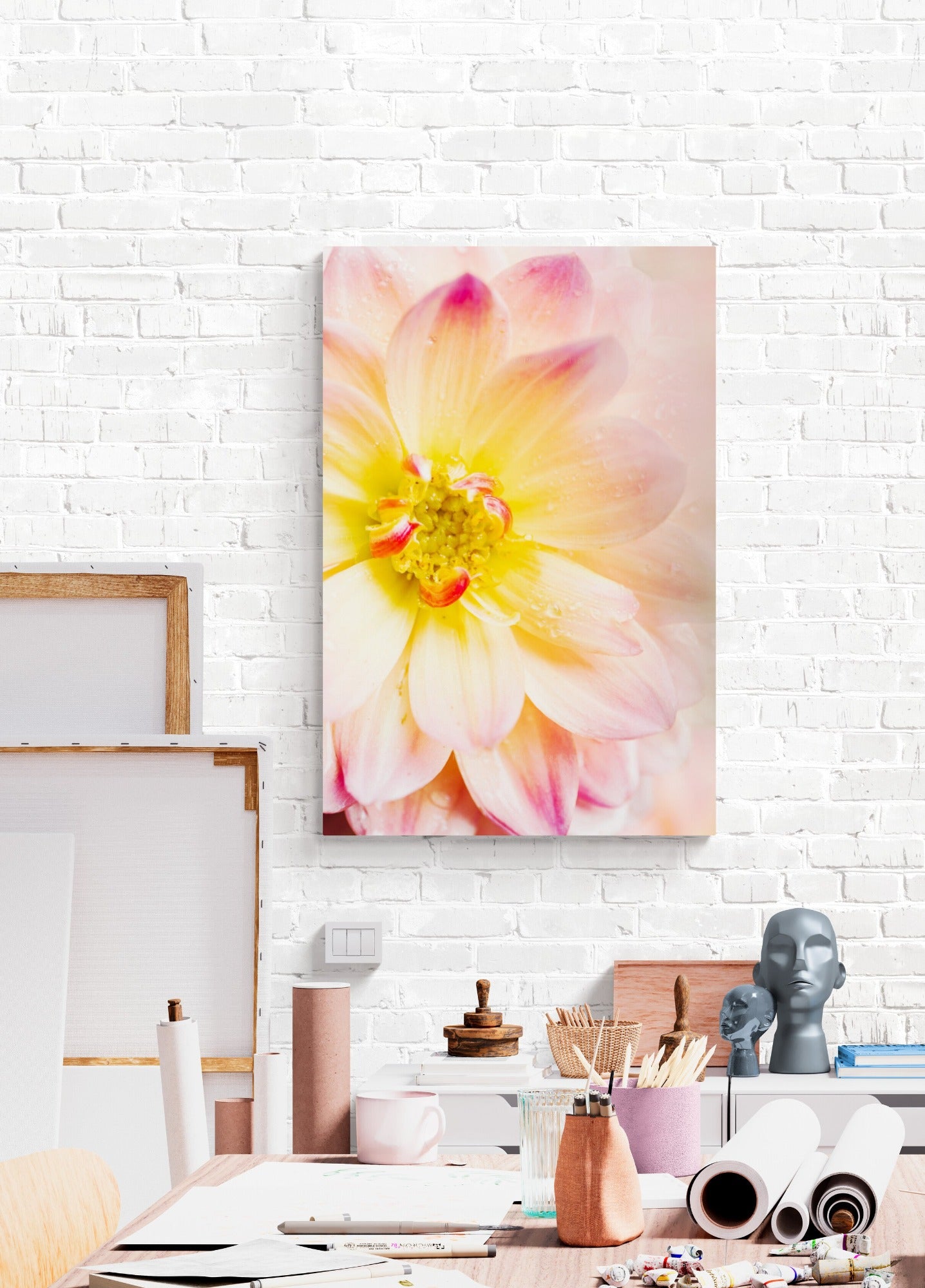 Pink and yellow dahlia photograph print displayed in an artist studio