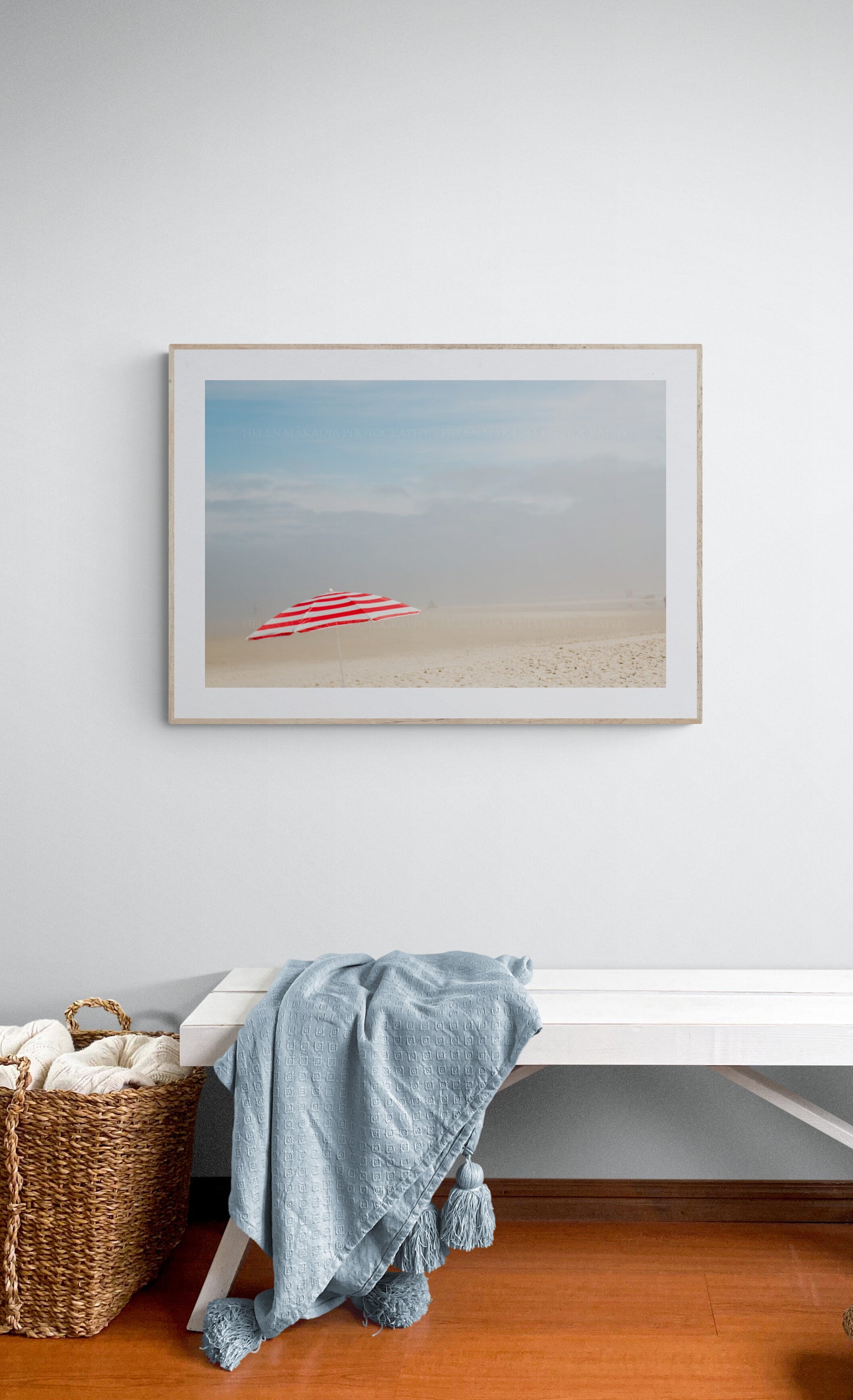 Red and white beach umbrella photograph as wall art in an entryway