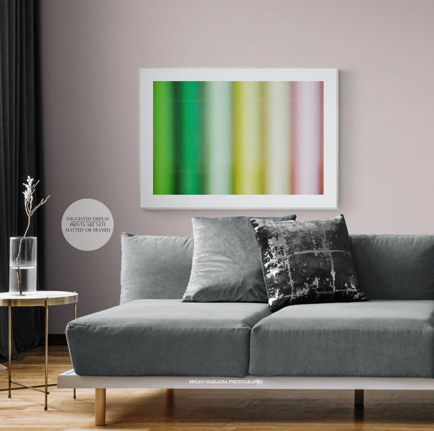 A colorful abstract print of spring colors palette, framed in a living room.