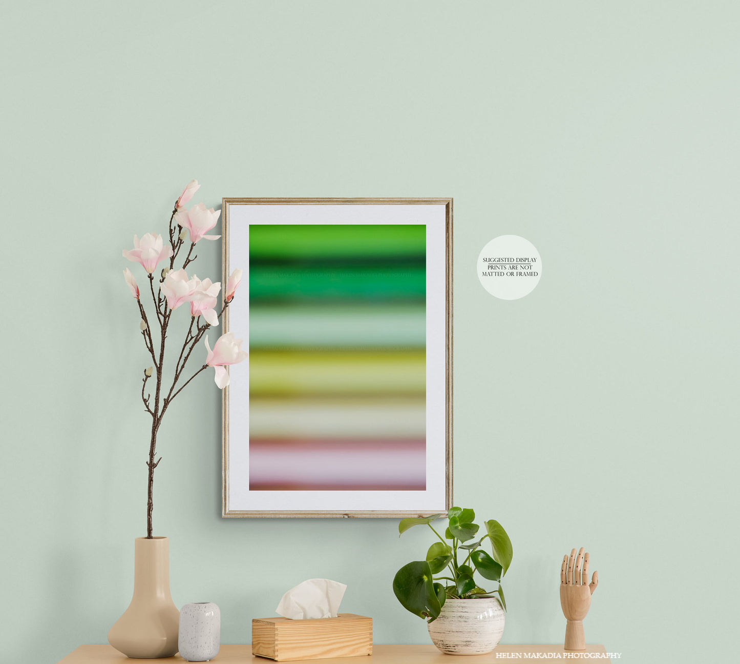 A colorful abstract print of spring colors palette, framed in an entryway.