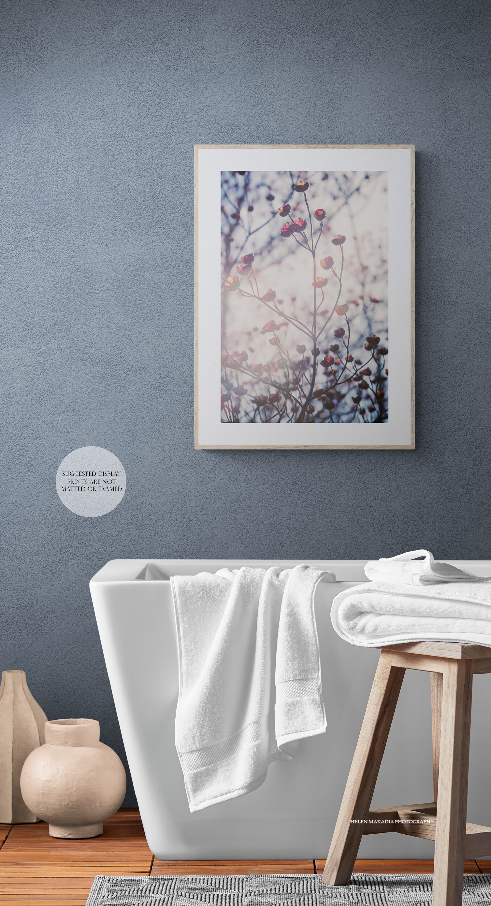 Sunlit pink dogwood blooms photograph as wall art in a bathroom